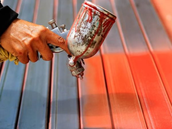 People are working with spray paint to prevent rust.